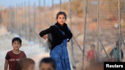 Syrian children arrive at a camp for internally displaced persons, in Atimah village, Idlib province, Syria, Sept. 11, 2018.