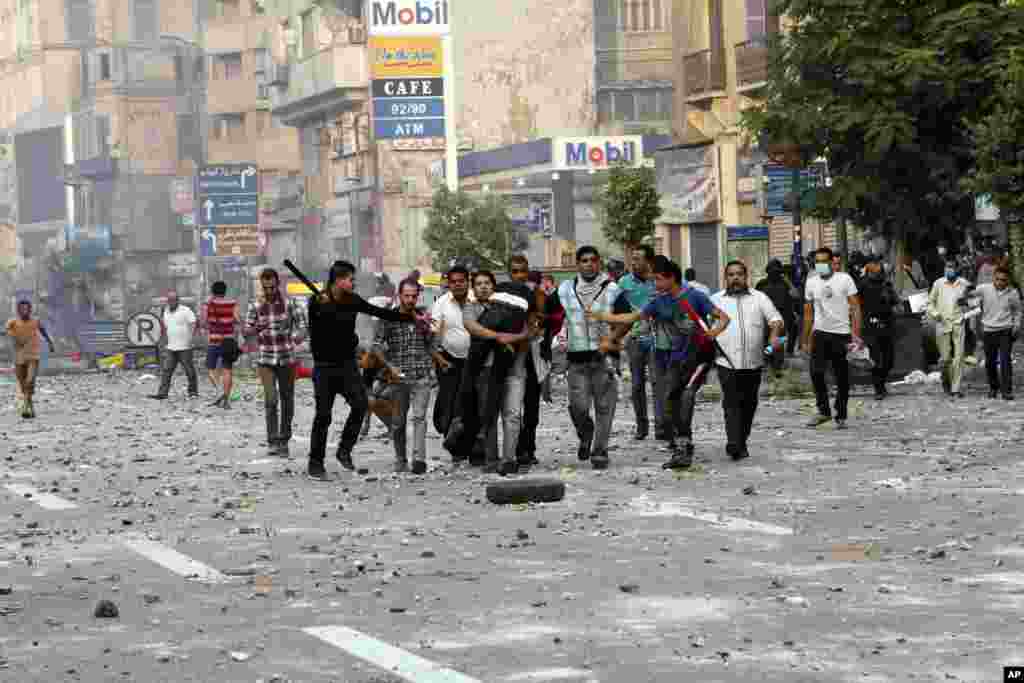 Egyptian security forces and civilians detain a supporter of ousted Egyptian President Mohamed Morsi near Ramsis Square, Cairo, Oct. 6, 2013