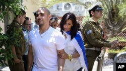 Elor Azaria escorted by his mother arrives to Israeli military court in Tel Aviv, Sunday, July 30, 2017.