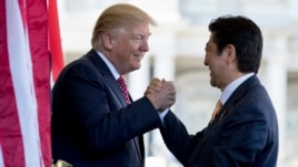 President Donald Trump welcomes Japanese Prime Minister Shinzo Abe outside the West Wing of the White House in Washington, Feb. 10, 2017.