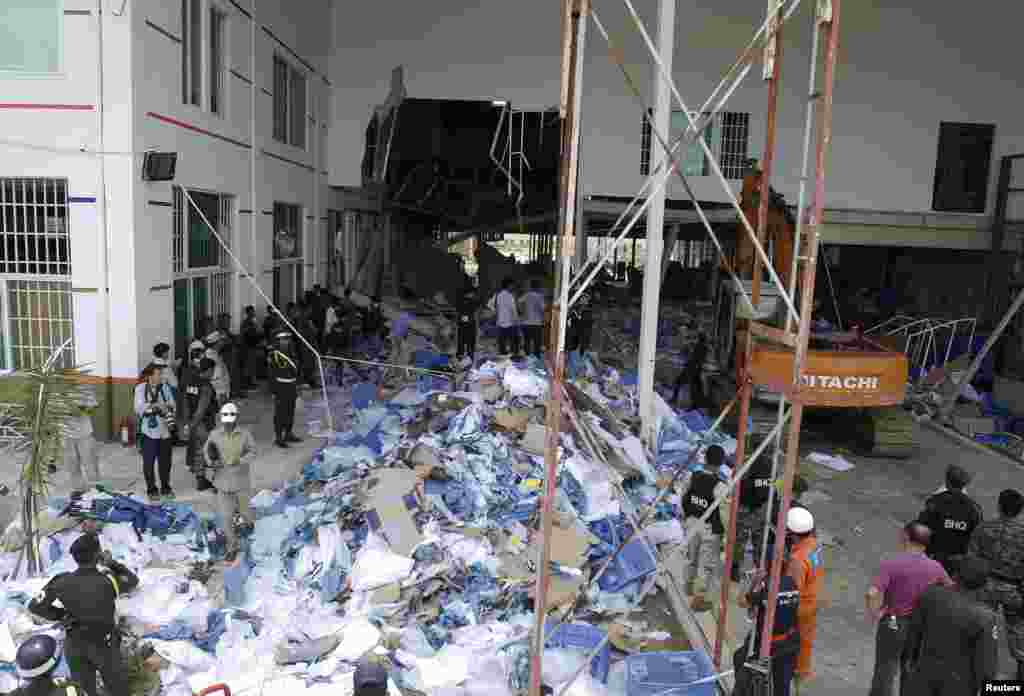 Rescue workers and soldiers search through a site of the accident in a shoe factory in Phnom Penh, May 16, 2013.