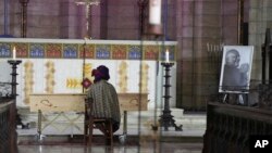 Mpho Tutu, sits with the coffin of her father Anglican Archbishop Emeritus Desmond Tutu during his funeral at the St. George's Cathedral in Cape Town, South Africa, Jan. 1, 2022. 