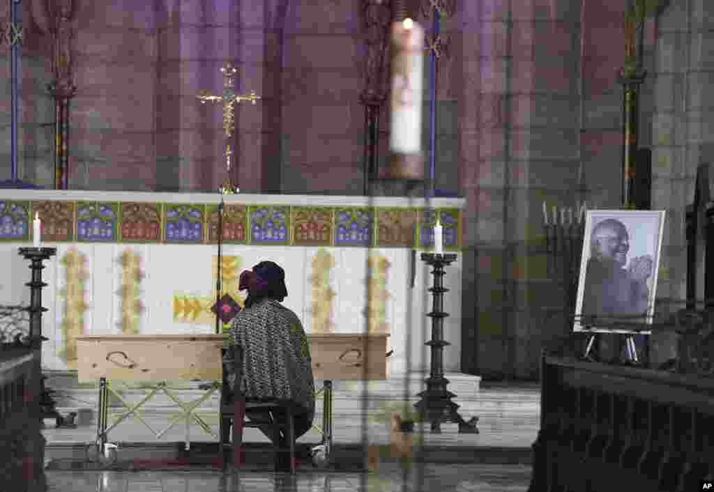 Mpho Tutu, sits with the coffin of her father Anglican Archbishop Emeritus Desmond Tutu during his funeral at the St. George's Cathedral in Cape Town, South Africa, Jan. 1, 2022. Tutu, the Nobel Peace Prize-winning activist for racial equality and LGBT rights died at the age of 90.