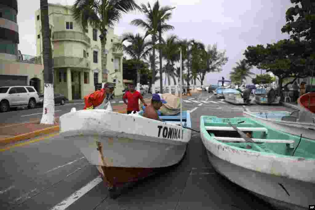 Pescadores veracruzanos en México mudan sus botes a una avenida costera antes de la llegada del huracán Franklin. Agosto 9 de 2017.