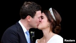 Britain's Princess Eugenie and Jack Brooksbank kiss as they leave after their wedding at St George's Chapel in Windsor Castle, Windsor, Britain Oct. 12, 2018.