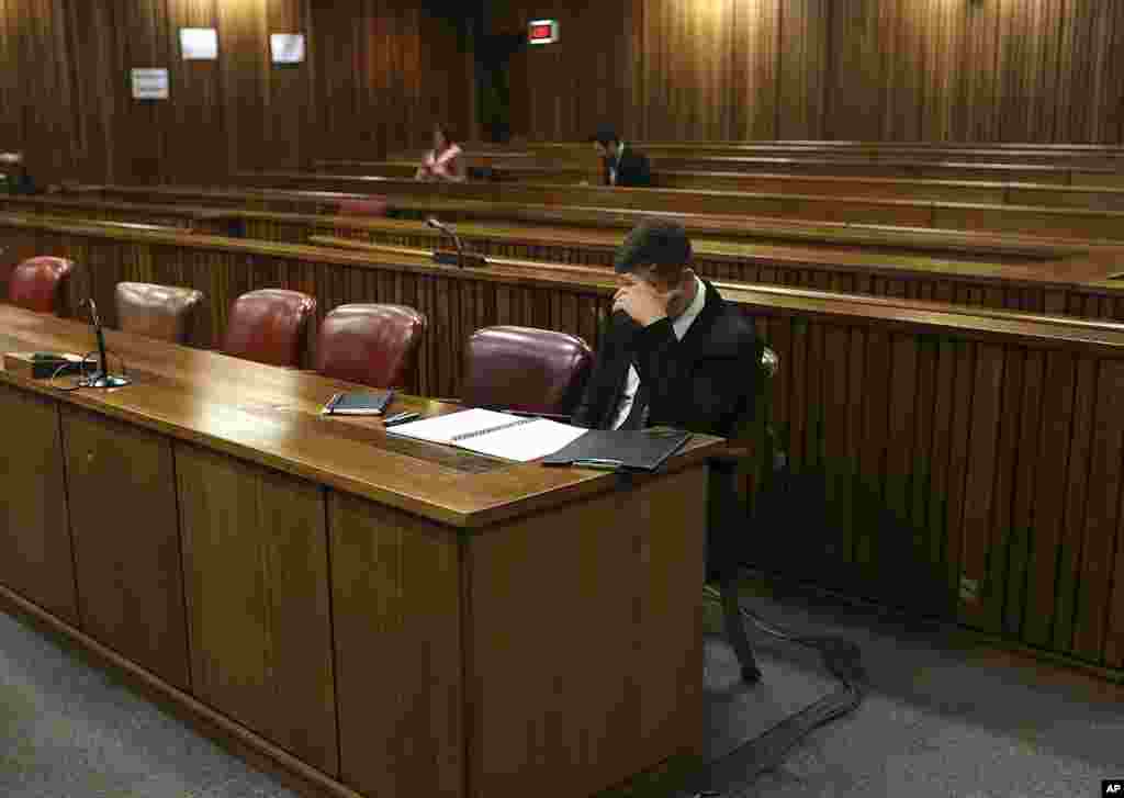 Oscar Pistorius sits in court before the fourth day of sentencing proceedings in the high court in Pretoria, South Africa, Oct. 16, 2014.
