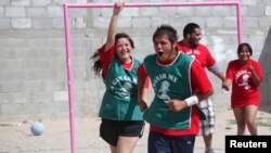 Youths participating in the "A Ganar" (To Win) program celebrate after scoring a goal during soccer training in Ciudad Juarez June 19, 2014.