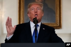 In this Oct. 13, 2017 file photo, President Donald Trump makes a statement on Iran policy in the Diplomatic Reception Room of the White House in Washington.