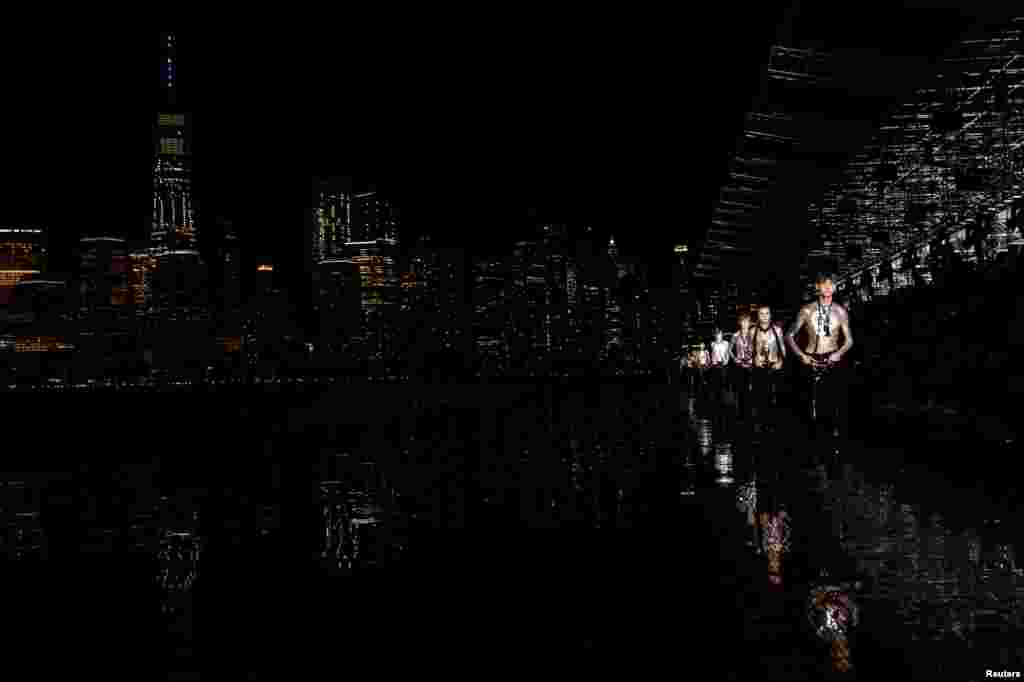 Models present creations from the Saint Laurent Men&#39;s Spring Summer 2019 collection during a runway show in Liberty State Park in New Jersey, June 6, 2018.