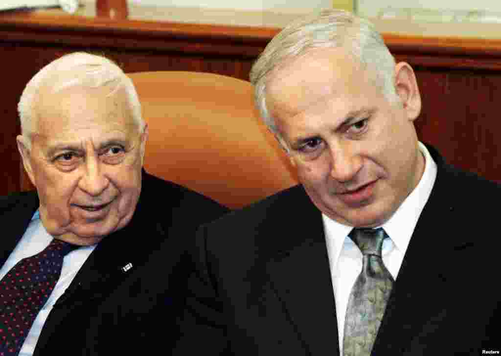 Israeli Prime Minister Ariel Sharon and Finance Minister Benjamin Netanyahu attend a meeting in Jerusalem, Jan. 16, 2005.