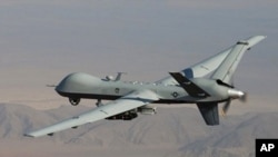 Undated handout photo provided by U.S. Air Force shows MQ-9 Reaper, armed with GBU-12 Paveway II laser guided munitions and AGM-114 Hellfire missiles