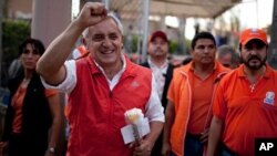 Otto Perez Molina, of the Patriotic Party, greets supporters as he campaigns in Guatemala City, Sunday, Oct. 30, 2011. (AP Photo/Rodrigo Abd)