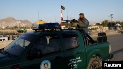 An Afghan policeman keeps watch at a checkpoint during parliamentary elections in Kabul, Afghanistan, Oct. 20, 2018.