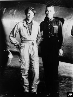 Famed aviator Amelia Earhart and her navigator, Fred Noonan, pose in this file photo in front of their twin-engine Lockheed Electra in Los Angeles at the end of May, 1937. (AP Photo, File)