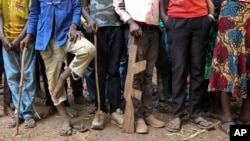 FILE - Former child soldiers stand in line for registration with UNICEF to receive a release package in Yambio, South Sudan, Feb. 7, 2018.