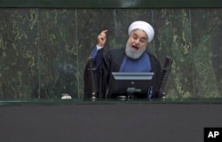 Iranian President Hassan Rouhani speaks in a session of the parliament while answering questions of lawmakers, in Tehran, Aug. 28, 2018.