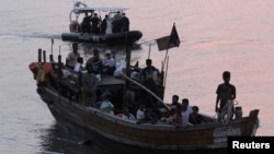 Rohingya refugees, who were intercepted by Malaysian Maritime Enforcement Agency off Langkawi island, are escorted in their boat as they are handed over to immigration authorities, at the Kuala Kedah ferry jetty in Malaysia, April 3, 2018. On Friday, five Rohingya were rescued off the coast of Sumatra.