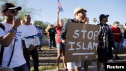FILE - Demonstrators shout during a "Freedom of Speech Rally Round II" outside the Islamic Community Center in Phoenix, Arizona May 29, 2015.