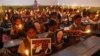 Schoolchildren hold candles and portraits of former South African President Nelson Mandela during a prayer ceremony at a school in the western Indian city of Ahmedabad, Dec. 6, 2013.