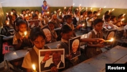 Children in India hold a prayer ceremony at school to honor former South African President Nelson Mandela.