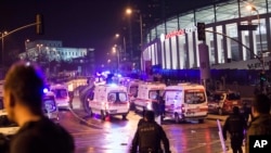 Police officers and ambulances fill the street next to the Besiktas football club stadium, in Istanbul, late Saturday, Dec. 10, 2016. 