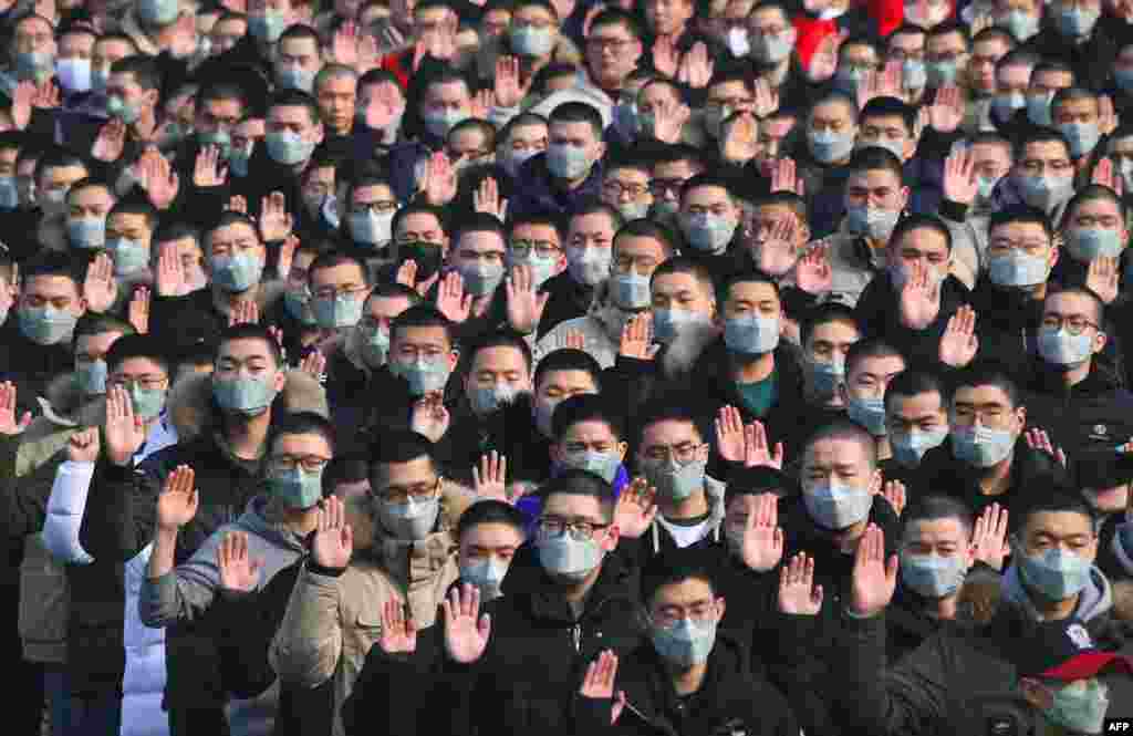 South Korean military conscripts wear face masks to protect themselves against a wave of fine dust that has hit the Korean Peninsula, during their entrance ceremony at the army training center in Nonsan.