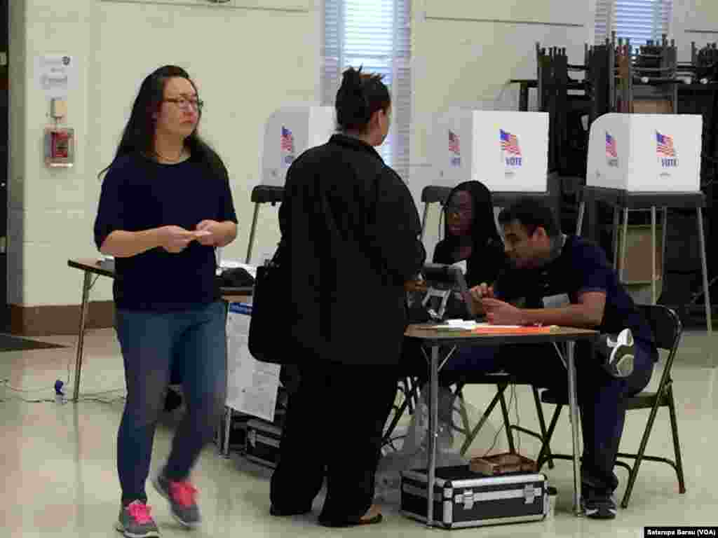 Voters arrive at a polling station at Watkins Mill Elementary School in Montgomery Village, Maryland, April 26, 2016. 