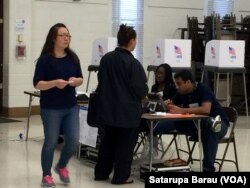 Voters arrive at a polling station at Watkins Mill Elementary School in Montgomery Village, Maryland, April 26, 2016.