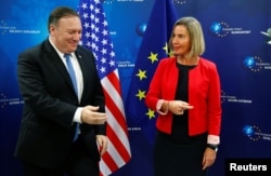 FILE - U.S. Secretary of State Mike Pompeo poses with EU Foreign Policy chief Federica Mogherini ahead of a meeting in Brussels, Belgium, July 12, 2018.
