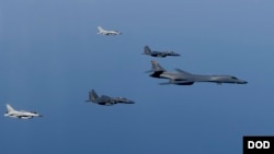 FILE - A U.S. Air Force B-1B Lancer leads a formation of Republic of Korea Air Force F-15K Slam Eagles and F-16 Fighting Falcons during a bilateral mission into South Korean airspace March 21, 2017.