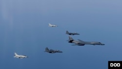 FILE - A U.S. Air Force B-1B Lancer leads a formation of Republic of Korea Air Force F-15K Slam Eagles and F-16 Fighting Falcons during a bilateral mission into South Korean airspace March 21, 2017.