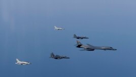 A U.S. Air Force B-1B Lancer leads a formation of Republic of Korea Air Force F-15K Slam Eagles and F-16 Fighting Falcons during a bilateral mission into South Korean airspace March 21, 2017.