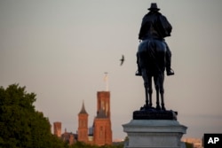 The Smithsonian Castle is visible at sunrise on the National Mall, May 15, 2019, in Washington.