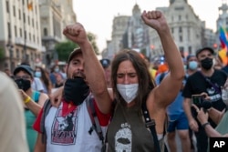 FILE - People shout slogans during a demonstration in support of Mexican Zapatistas in Madrid, Spain, Aug. 13, 2021.