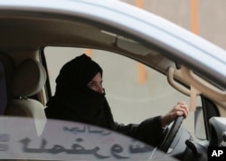 FILE - Aziza Yousef drives a car on a highway in Riyadh, Saudi Arabia, as part of a campaign to defy Saudi Arabia's ban on women driving, March 29, 2014.