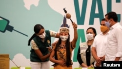 Vanderlecia Ortega dos Santos, or Vanda, from the Witoto indigenous tribe, receives the Sinovac coronavirus disease (COVID-19) vaccine, in Manaus, Brazil January 18, 2021.