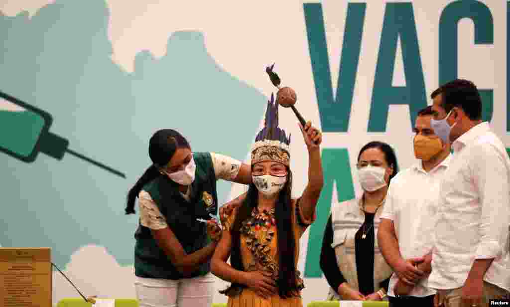 Vanderlecia Ortega dos Santos, or Vanda, from the Witoto indigenous tribe, receives the Sinovac coronavirus disease (COVID-19) vaccine, in Manaus, Brazil, Jan. 18, 2021.