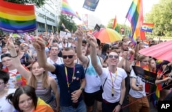People take part in a gay pride parade in Warsaw, Poland, June 9, 2018. The pride celebrations come as LGBTQ activists say a conservative turn in Poland is only motivating them to fight harder for their rights.