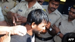Double gang-rape convict Siraj Rehmat Khan is brought to a police van before taken to court in Mumbai, April 4, 2014.