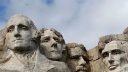 FILE - A raptor flies over Mount Rushmore on March 22, 2019, in Keystone, S.D. From left are former presidents George Washington, Thomas Jefferson, Theodore Roosevelt and Abraham Lincoln.