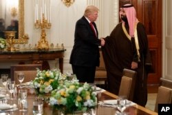 FILE - President Donald Trump shakes hands with Saudi Defense Minister and Deputy Crown Prince Mohammed bin Salman, Tuesday, March 14, 2017, in the State Dining Room of the White House in Washington.