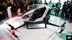 FILE - The EHang 184 autonomous aerial vehicle is unveiled at the EHang booth at CES International in Las Vegas, Jan. 6, 2016. The drone is large enough to fit a human passenger. 