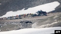Accident investigators and rescue personnel work at the wreckage of a Junkers JU52 aircraft in Flims, Aug. 5, 2018, after it crashed into Piz Segnas, a 3,000-meter (10,000-foot) peak in eastern Switzerland.