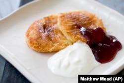 A Russian breakfast may include a cheese-filled pancake with fruit jam.