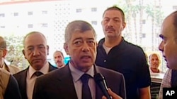 In this image from Egyptian State Television, Egyptian Interior Minister Mohamed Ibrahim responds to a reporter after an explosion near his convoy in Cairo, Sept. 5, 2013.