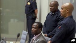 Dominic Ongwen, center, a senior commander in the Lord's Resistance Army, whose fugitive leader Kony is one of the world's most-wanted war crimes suspects, sits in the court room of the International Court in The Hague, Jan. 21, 2016.