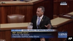 In this frame grab from video provided by C-SPAN, Rep. David Jolly, R-Fla. holds a container of mosquitoes while speaking of the House floor on Capitol Hill in Washington, Sept. 7, 2016. "The politics of Zika are garbage right now," the Florida lawmaker said in a short, angry speech condemning Congress for failing to pass legislation providing $1.1 billion to combat the mosquito-borne virus.