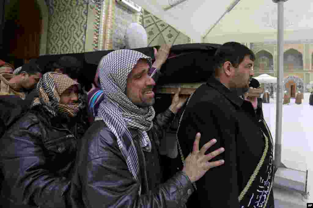 Mourners carry the coffin of an Iraqi soldier who was killed during clashes in Ramadi, during his funeral procession in Najaf, Jan. 6, 2014.