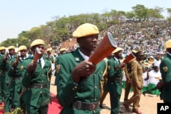 Zimbabwean soldiers march as Zimbabwean President Robert Mugabe arrive for the state burial of a former foreign minister Stan Mudenge, officiated by Zimbabwe President Robert Mugabe, in Harare, Monday, Oct. 8, 2012.