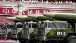 FILE PHOTO: Military vehicles carrying DF-26 ballistic missiles travel past Tiananmen Gate during a military parade to commemorate the 70th anniversary of the end of World War II in Beijing, China, September 3, 2015.